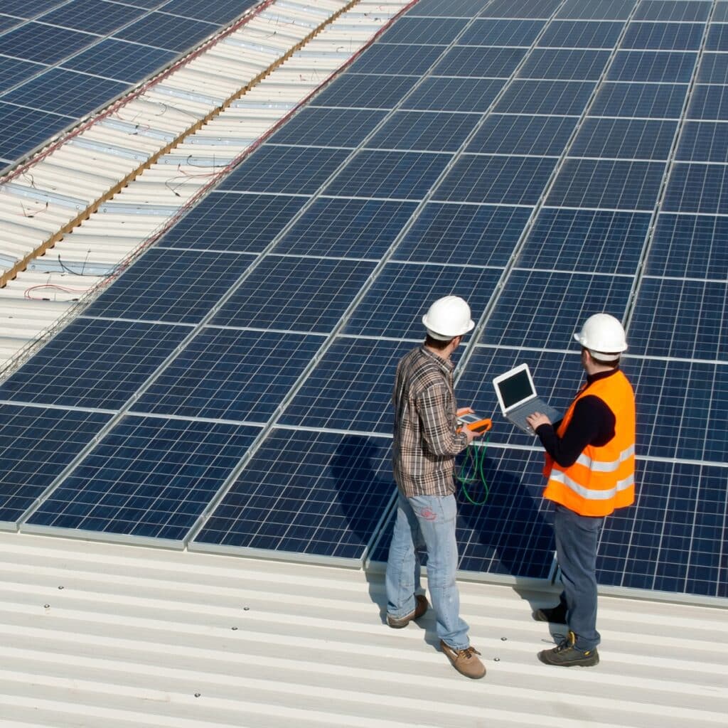 2 engineers next to solar pannels